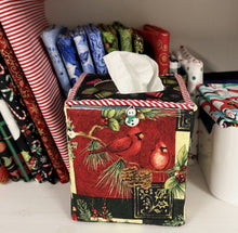 Load image into Gallery viewer, Tissue box cover with Christmas design featuring cardinals and foliage, surrounded by festive wrapping paper.