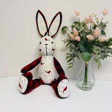 Load image into Gallery viewer, Stuffed bunny toy with plaid accents next to a vase of flowers on a white surface.