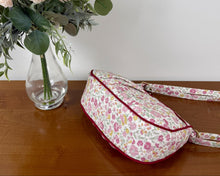 Load image into Gallery viewer, Floral-patterned bag on a wooden surface with a vase of flowers in the background