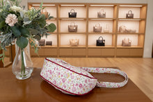 Load image into Gallery viewer, Floral-patterned bag on a wooden surface with a vase of flowers in the background