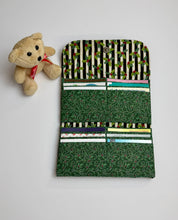 Load image into Gallery viewer, Fabric wallet with 12 cards slots and 2 pouch with christmas patterns next to a small teddy bear on a light gray background
