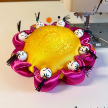 Load image into Gallery viewer, Decorative silk pincushion with pink fabric and white beads on a sewing machine
