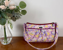 Load image into Gallery viewer, Floral-patterned handbag next to a vase with flowers on a wooden surface
