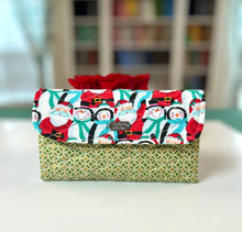 Load image into Gallery viewer, Fabric-wrapped gift with Christmas design on a white surface
