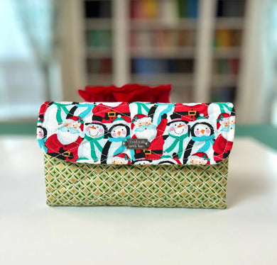 Fabric-wrapped gift with Christmas design on a white surface