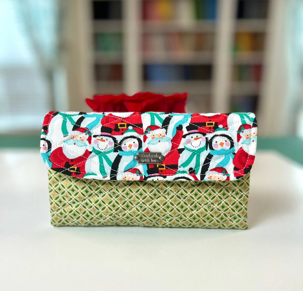 Fabric-wrapped gift with Christmas design on a white surface